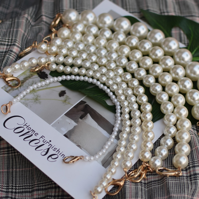 Elegant pearl strap for handbags and purses, featuring silver, gold, or black clasps.