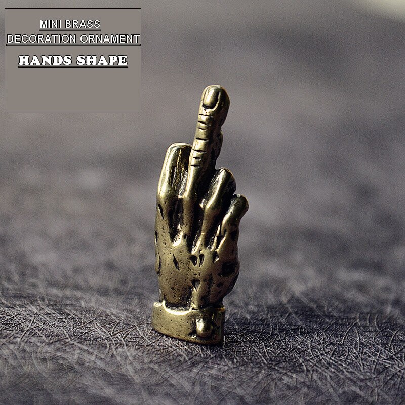 Humorous mini brass hand giving a 'finger up' gesture, a unique desk ornament.